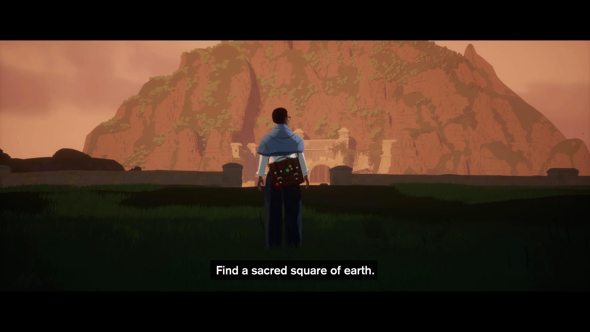 A screenshot of the cinematic part of the game with the main character in the center and a mountain on the background. Subtitles say "Find a sacred square of earth".