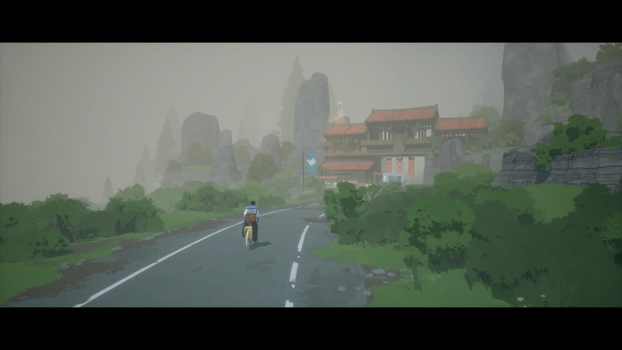 Main character rides on the bicycle through the fog by the road towards and asiam style gates surrounded by rocks and greens